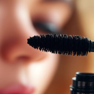 Close-up of clumpy mascara on eyelashes, illustrating common beauty issue and solutions.